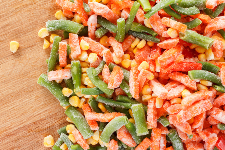 Mixed vegetables on cutting board as background