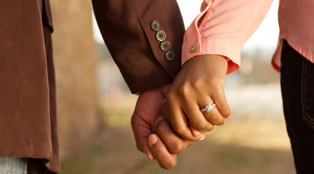 African American couple holding hands engaged