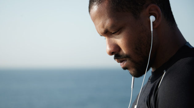 African American man stressed listening to music