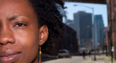 African American woman on city sidewalk