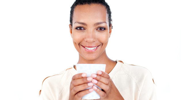 African American woman drinking cup smiling