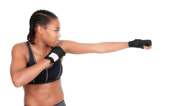 African American woman with braids boxing