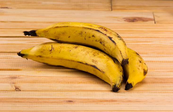 group of plantains on wooden table