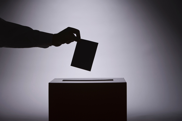 person voting with ballot