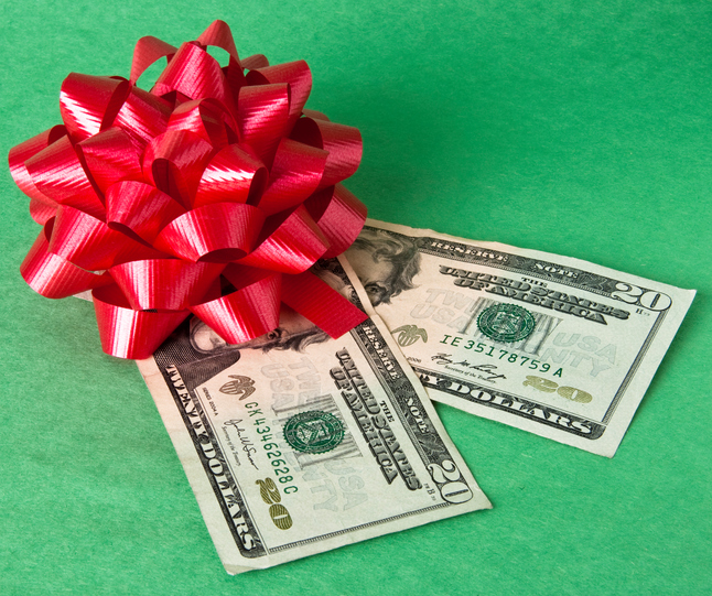 Bow and currency represents the cost of giving gifts during the holidays.