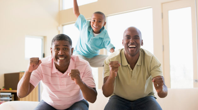 African American men watching football at home