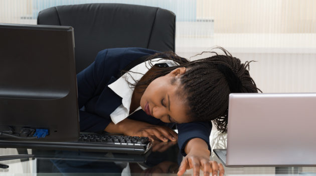 African American woman sleeping at desk