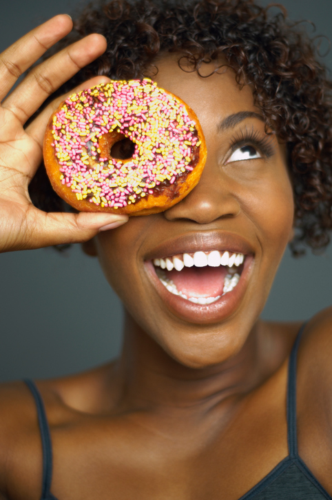 African American woman smiling with donut