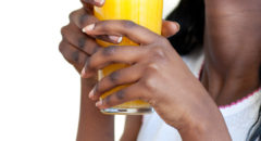 African American woman drinking orange juice