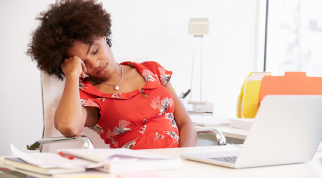 African American woman sleeping at work