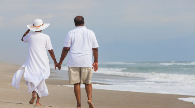 Senior African American couple walking on beach