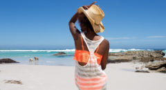 African American woman sitting on beach