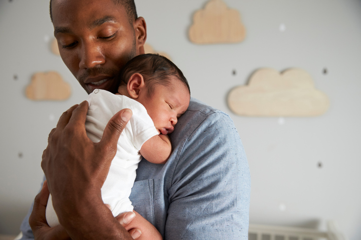 African American father holding newborn baby