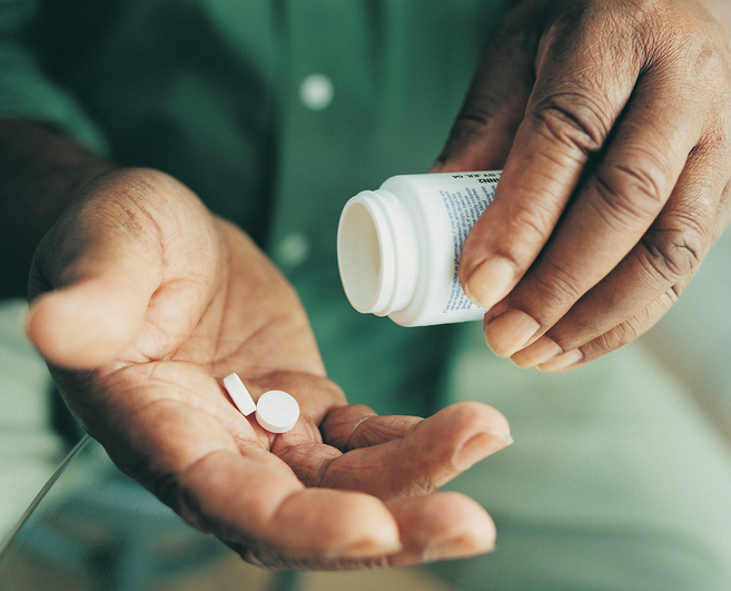 African American man taking medicine pills