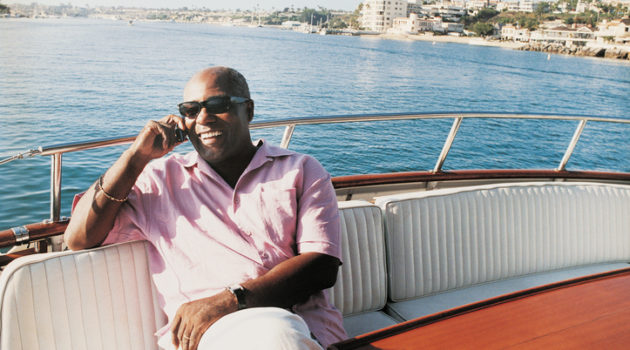 Older African American man on boat summer vacation