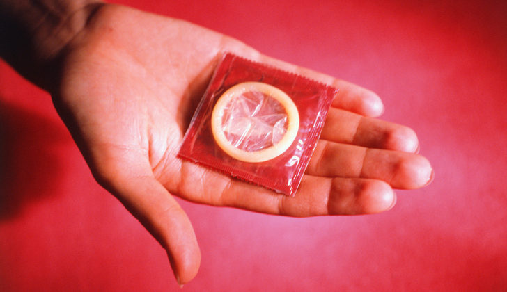 Person showing condom, Close-up of hand