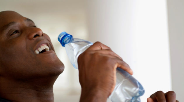 African American man drinking bottle water