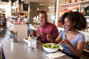 African American couple eating in restaurant
