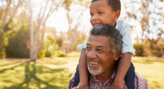 African american grandfather with grandson outside