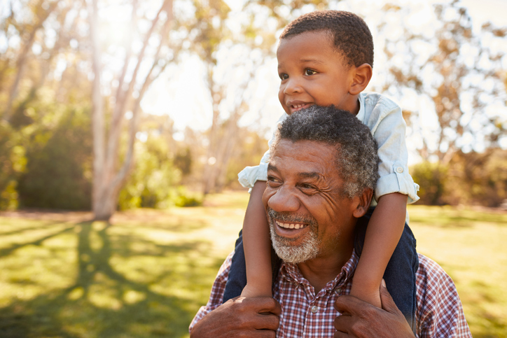 African american grandfather with grandson outside