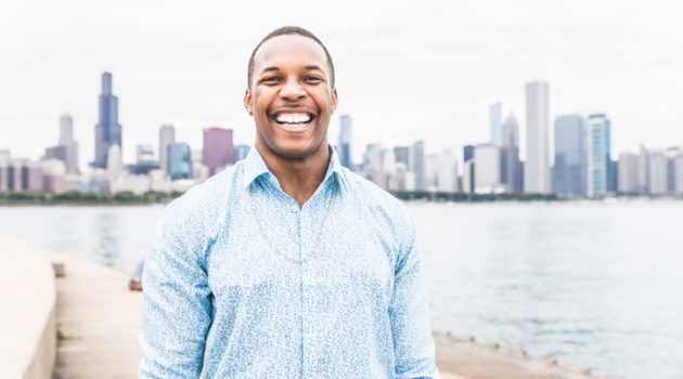 African American man smiling outside white teeth