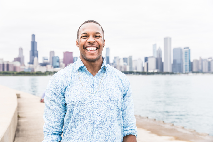 African American man smiling outside white teeth