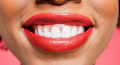 African American woman smiling white teeth red lipstick