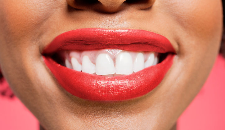 African American woman smiling white teeth red lipstick