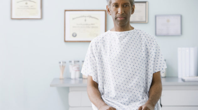 African man wearing hospital gown