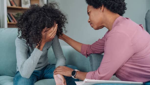 a woman comforting a crying woman